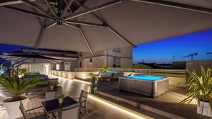 An outdoor terrace with a pool table, seating, and a hot tub. - VI SUITES (Viareggio)