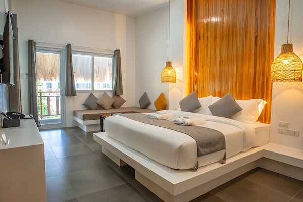 Deluxe Triple Room | Minibar, in-room safe, desk, laptop workspace