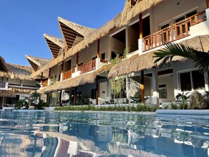 A resort with multiple buildings featuring thatched roofs and balconies. - Bathala Resort (Panglao)