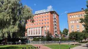 A large hotel building with a sign reading "GRAND HOTEL." - 1BR with Sauna, Rooftop Terrace & Amazing Views (Tampere)