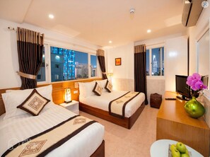 A hotel room with two beds, a desk, a TV, and a view of the cityscape. - Felix Hotel (Ho Chi Minh City)