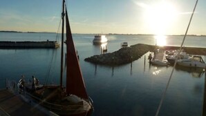 Un puerto deportivo con barcos amarrados, agua tranquila y cielo despejado.