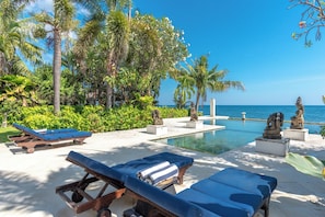 An infinity pool, pool loungers