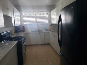 Fridge, microwave, stovetop, coffee/tea maker