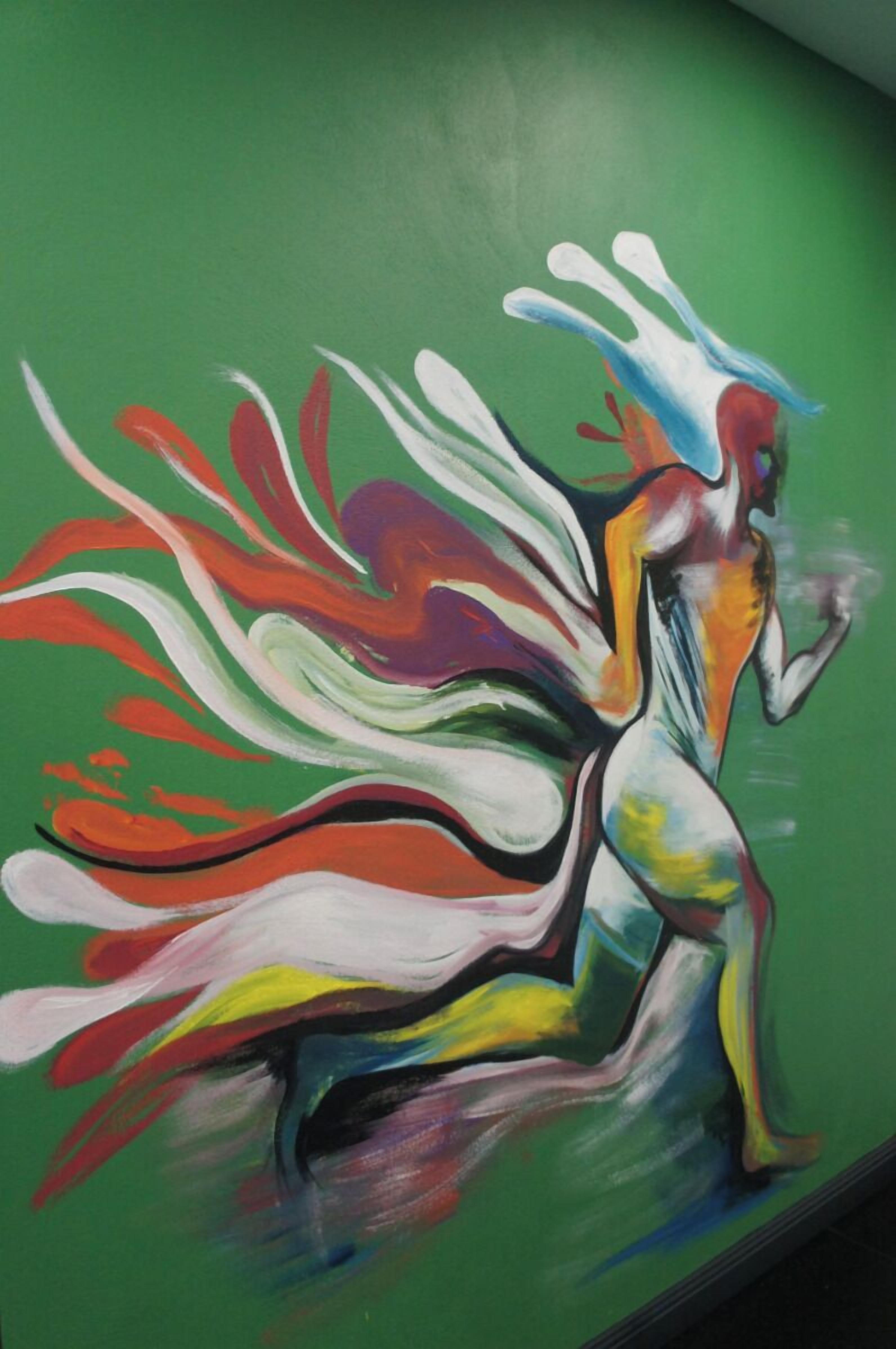 A vibrant abstract painting on a green wall.