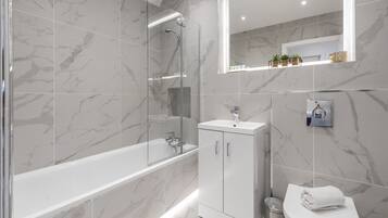 Combined shower/bathtub, hair dryer, towels, soap