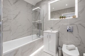 Combined shower/tub, hair dryer, towels, soap