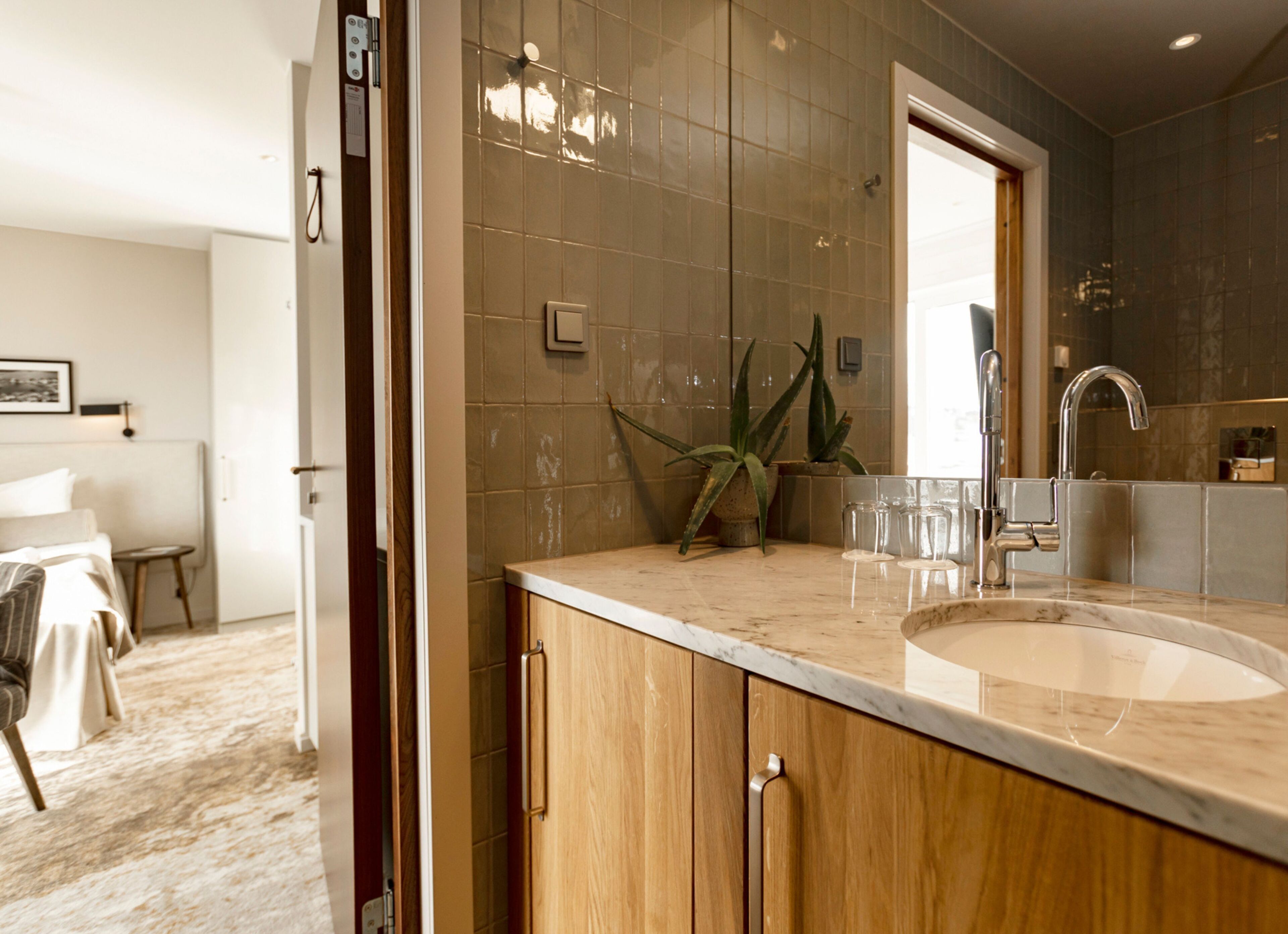 A modern bathroom with a large sink, wooden cabinets, and a mirror.