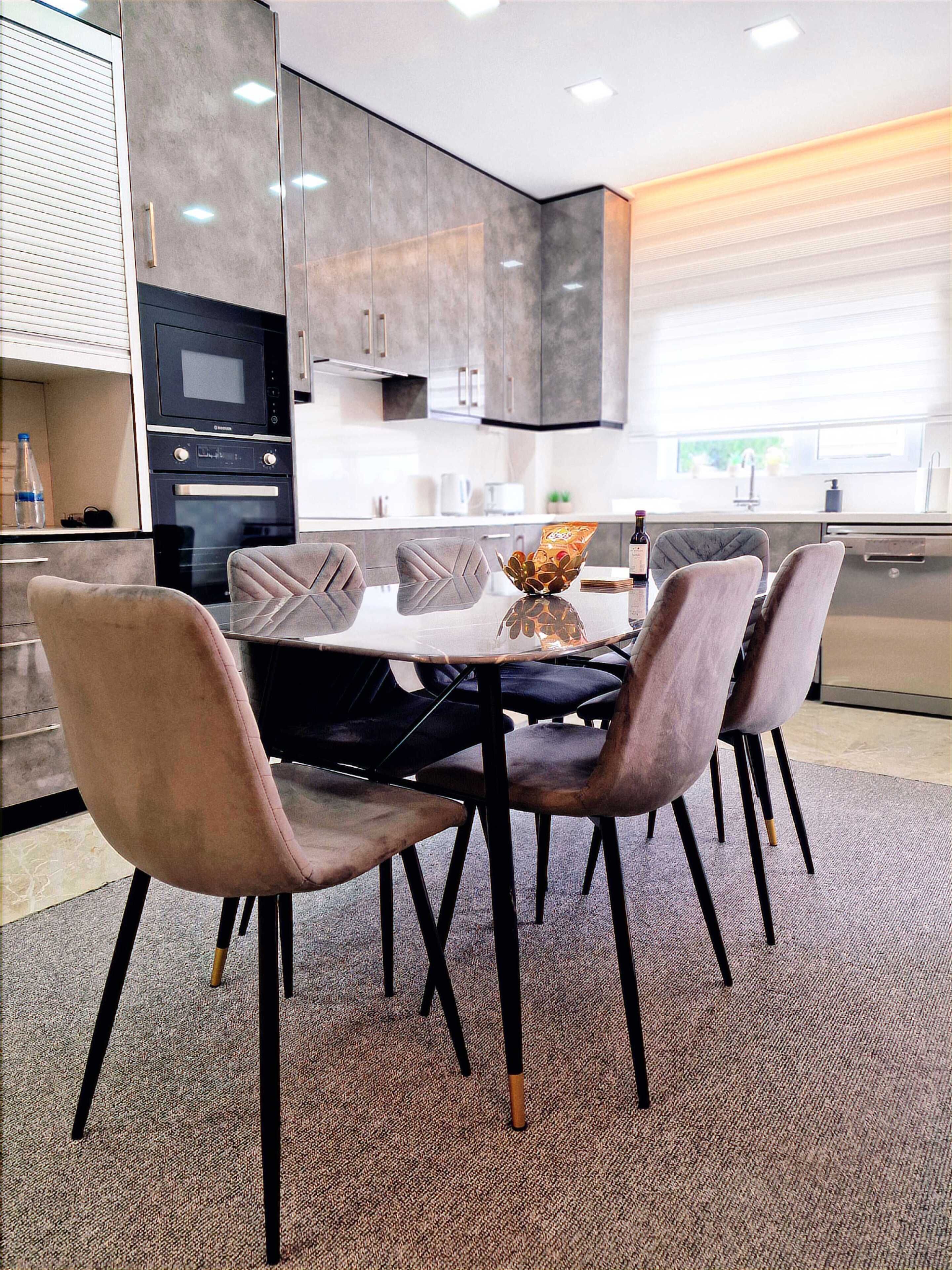 A modern kitchen with a dining area.
