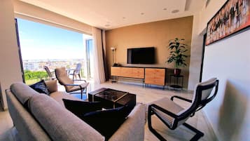 Superior Apartment | Living area | 43-inch Smart TV with satellite channels, TV