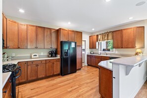 Kitchen with ample counter space, dishwasher & Keurig coffeemaker.