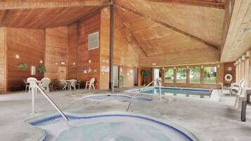 A wooden cabin with a pool area, including a hot tub and a standard pool.