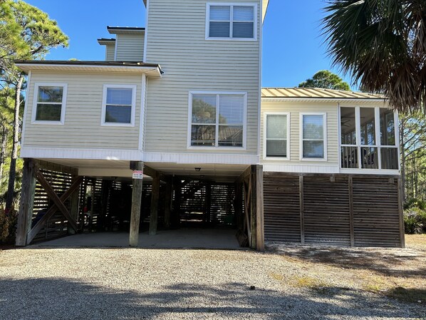 A two-story house with a covered garage and a security warning sign. - Awesome St George Island Home, Walk to Beach! PET FRIENDLY (St George Island)