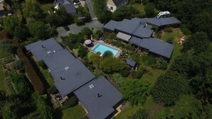 A residential area with multiple houses, a swimming pool, and a well-maintained garden.