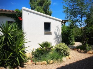 Surrounded by lush greenery and natural stone, this serene retreat offers a peaceful escape.