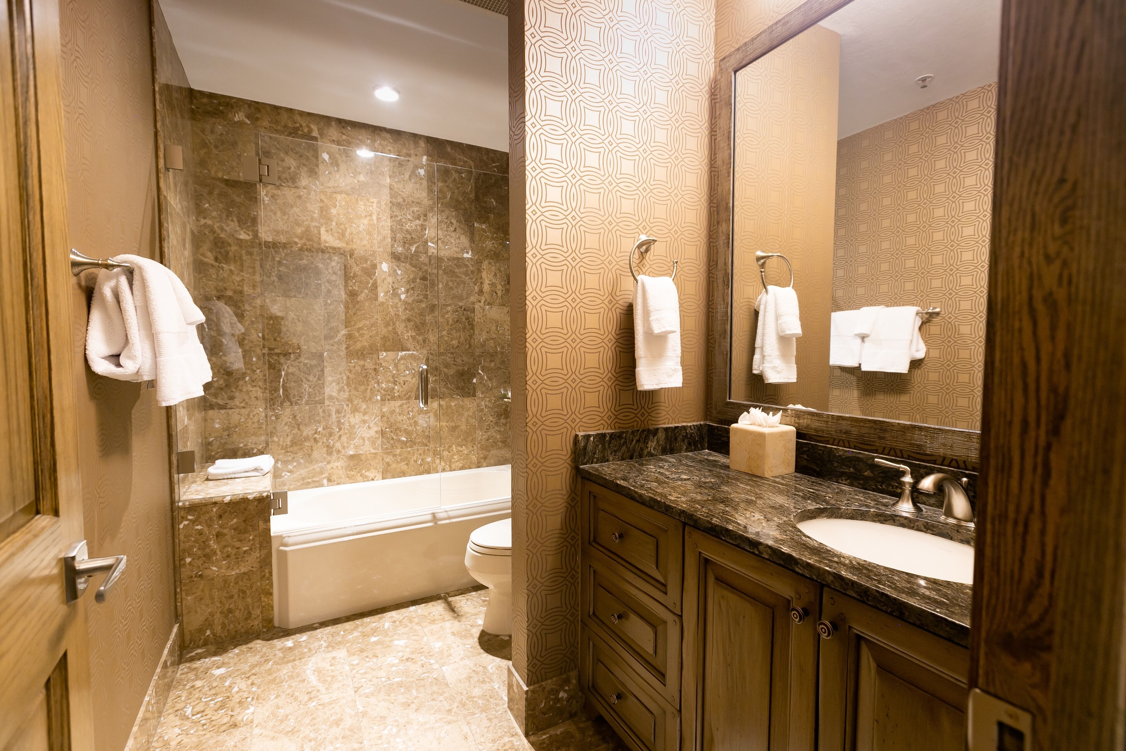 A bathroom with a bathtub, toilet, and sink.
