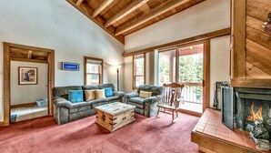 A cozy living room with a fireplace, a sofa set, and a wooden ceiling. - Northstar Tahoe Summer Resort Condo: Pools, Pickleball, Hike Trails, 2BR 2BA (Truckee)