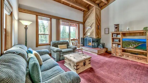 A cozy living room with a fireplace, comfortable seating, and a television. - Northstar Tahoe Summer Resort Condo: Pools, Pickleball, Hike Trails, 2BR 2BA (Truckee)