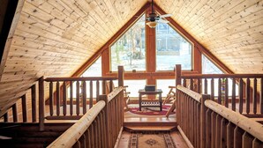 A wooden interior with a high ceiling, a central staircase, and a large window offering a view of the outside. - Rustic Log Cabin By Bryce Resort XL Game Room Fire Pit Pets Friendly & More (Mount Jackson)
