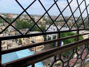 A view through a metal fence of a cityscape with various buildings, including residential and commercial structures. - Lovely 2-bedroom in Mombasa (Mombasa)
