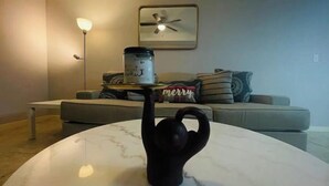 A modern living room with a marble coffee table, a black teapot, and a decorative item on the table. - Lavender home: King & Queen (Edinburg)