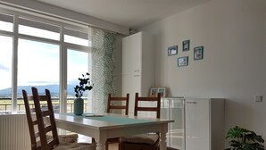 A dining area with a table, chairs, and a view of the outdoors. - Living Home (Sibiu)