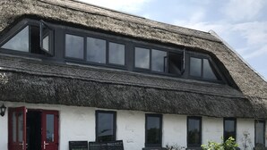 A building with a thatched roof and a sign reading "POTA".