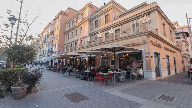 A street with outdoor seating at a restaurant named "GERIA." - Near Vatican Museums Rome (Roma)