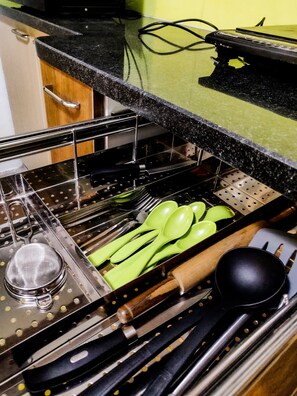 Kitchen essentials at your fingertips, with a convenient utensil organizer holding all the necessary tools.