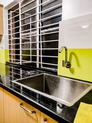 Sink, stove, and window in a well-equipped kitchen.