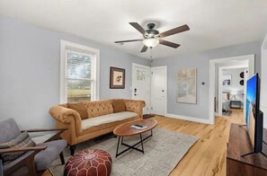 Relax in this inviting living room with a sofa, coffee table, and television.
