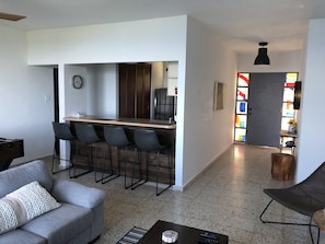 Relax in this open-plan living space with a fully equipped kitchen and comfortable seating area.