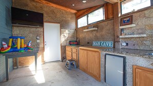 A kitchen with wooden cabinets, a refrigerator, a sink, and a window.