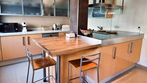 A modern kitchen with a wooden island, stainless steel appliances, and a large window. - Magnificent One Bedroom Apartment in Marbella Center. (Marbella)