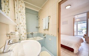 Bathtub, hair dryer, towels