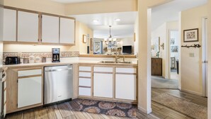 A compact kitchen with a dishwasher, a coffee maker, and a sink. - Nonnie's Nest -     Peaceful Walk-In Condo Near Lake Taneyco (Branson)