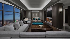 A modern hotel room with a large sofa, a coffee table, and a TV. - Wyndham Grand Zaozhuang (Zaozhuang)