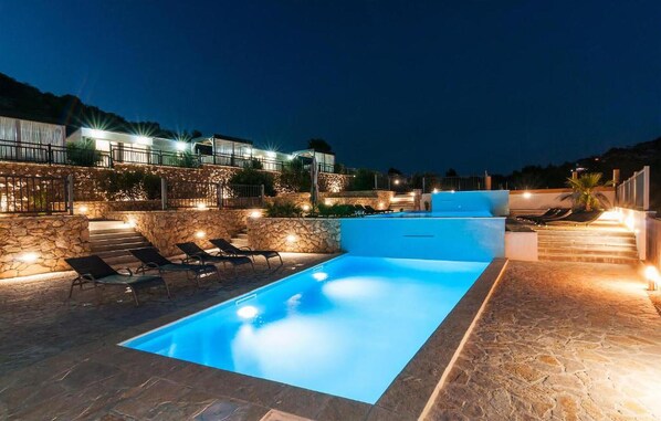 Relax by the pool surrounded by steps and balconies.