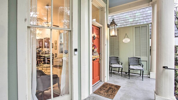 A porch with two chairs, a red door, and a sign reading "Welcome Porch". - Perfect Location: Inviting Uptown New Orleans Apt! (New Orleans)