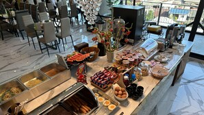 A buffet with various food items and utensils, including hot dogs, cheese, and eggs. - S3 Siam Bangkok (Bangkok)