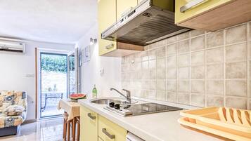 Apartment (Premium One Bedroom Apartment with Te) | Private kitchen | Fridge, dining tables