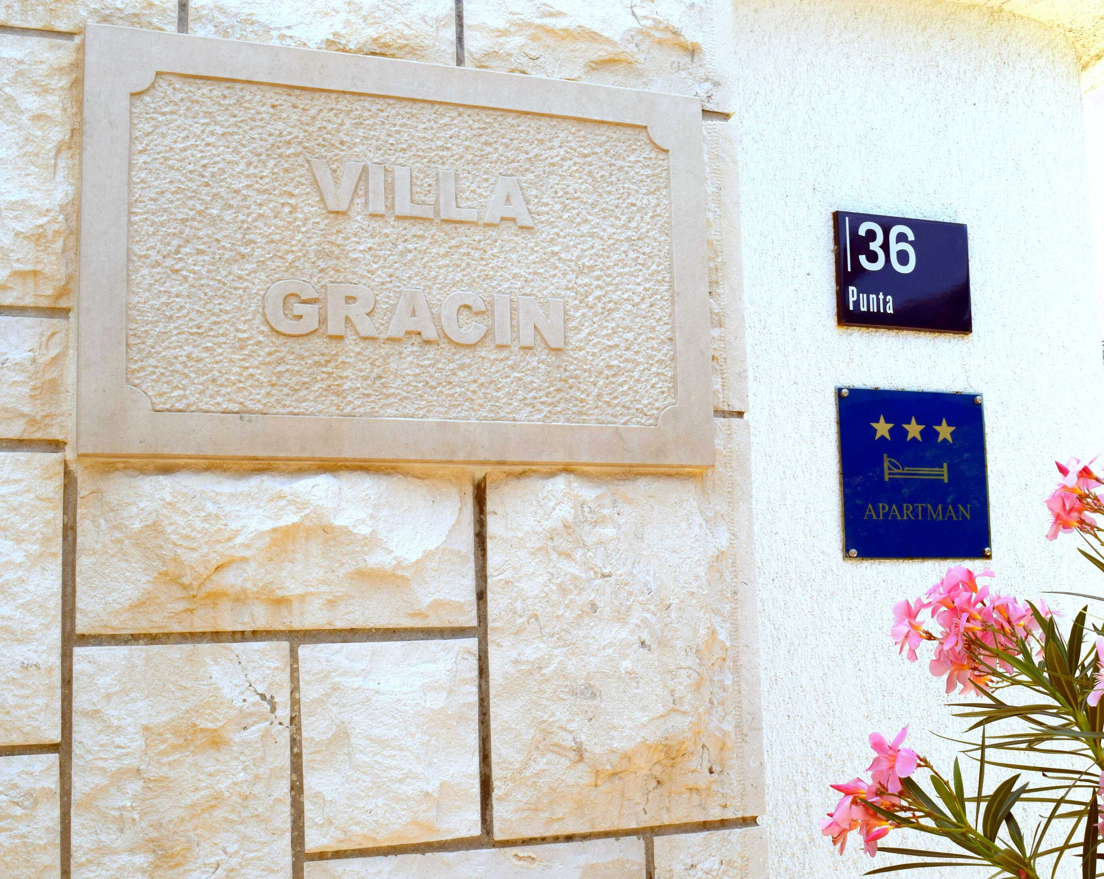 A building facade with a sign reading "VILLA GRACIN" and a plaque indicating "36 PUNTA".