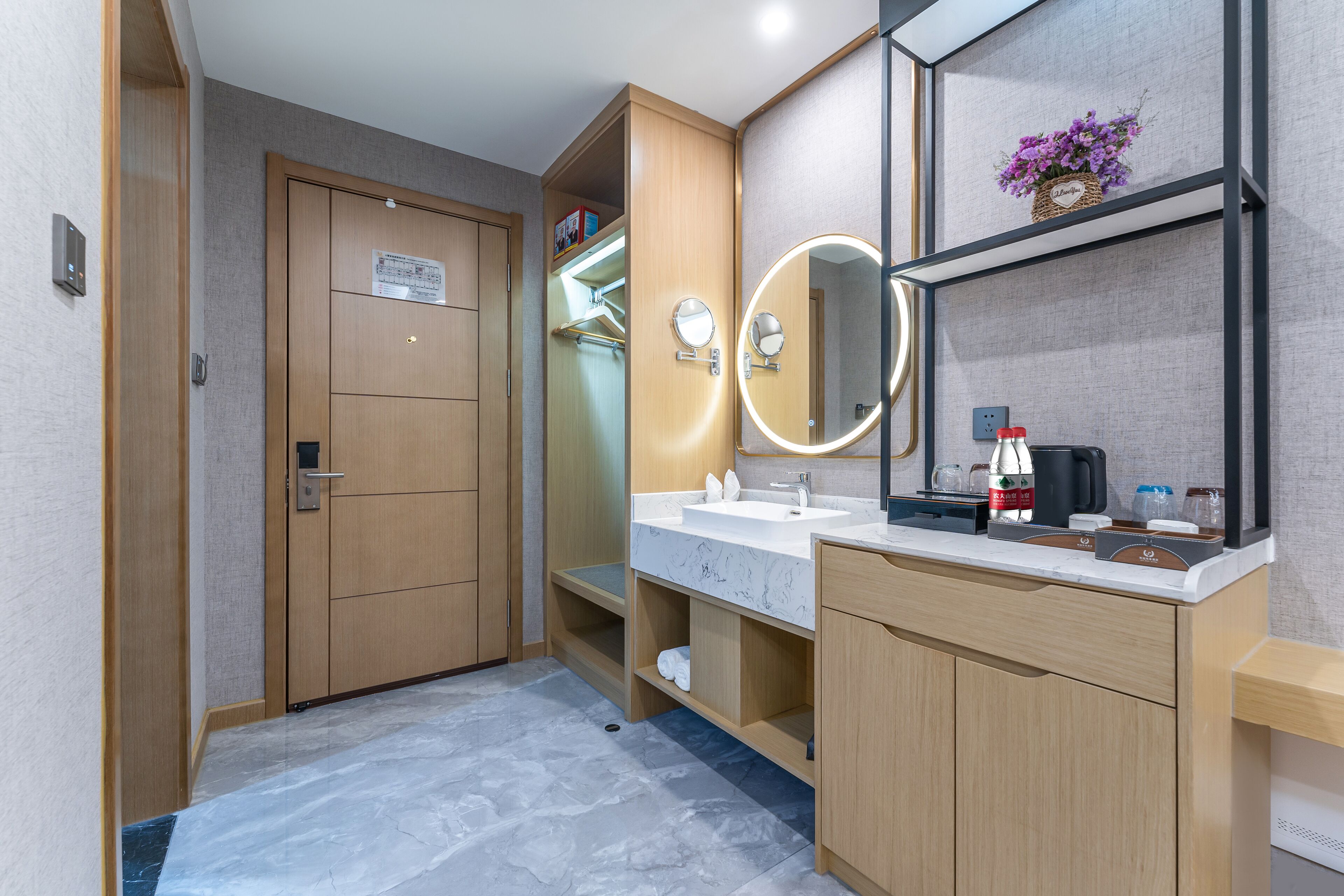 A modern bathroom with a wooden vanity, a large mirror, and a built-in shower.