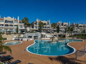 A resort with a large pool, multiple balconies, and a building labeled 'LILYS'.