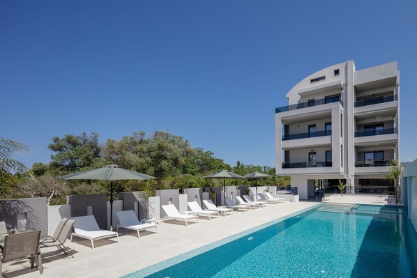 Seasonal outdoor pool, open 8:00 AM to 9:00 PM, pool umbrellas