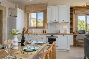 Enjoy meals with a view from the kitchen's large window overlooking the surrounding landscape.
