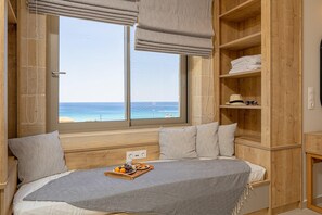 Enjoy a serene sea view from the large window, with a bed and storage space available.