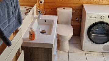 Shower, hair dryer, slippers, towels