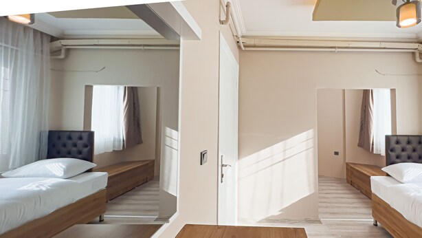 A modern hotel room with a wooden floor, two beds with headboards, a wooden bench, and a large mirror. - Helen Inn  (Izmir)