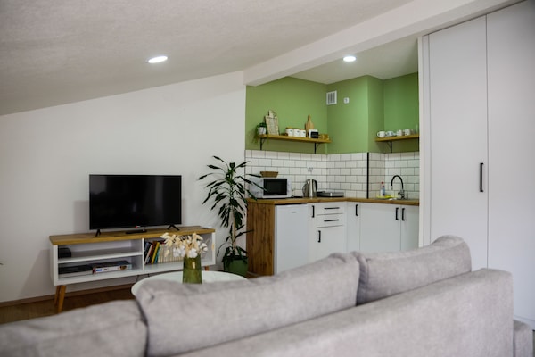 Air-conditioned open plan living room with a kitchen, sitting and dining areas